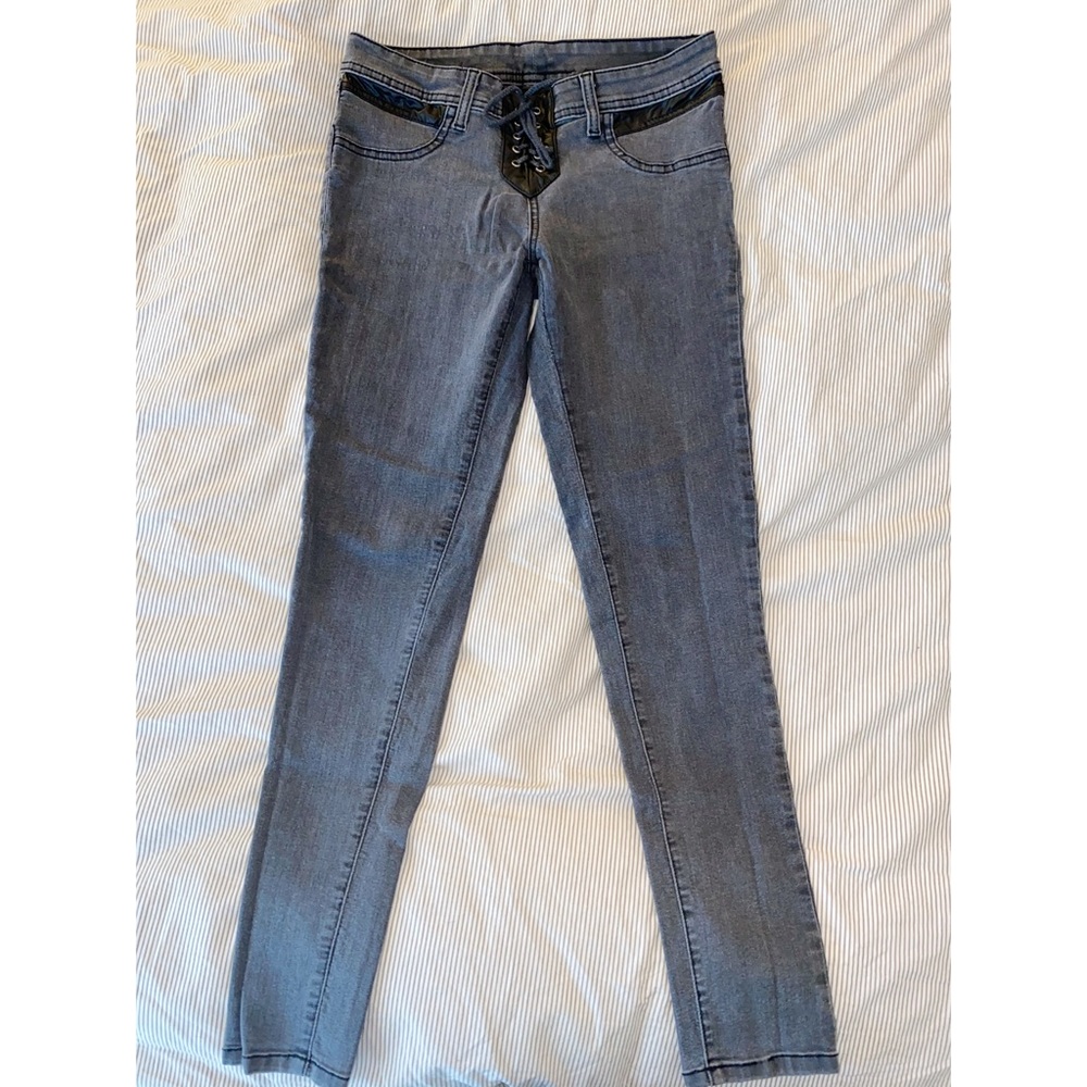 Grey jeans with black leather and tie up front